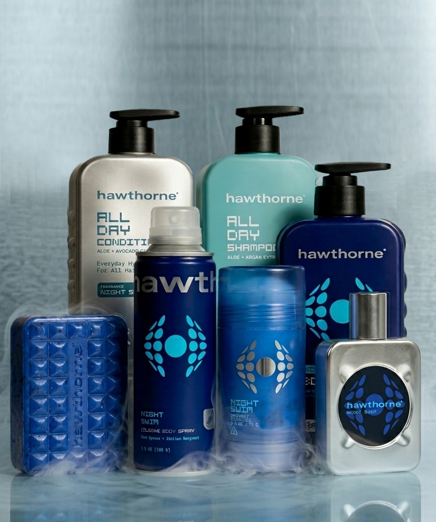 A set of Hawthorne's The Night Swim System personal care products—shampoo, conditioner, body wash, deodorant, body spray, bar soap, and cologne—arranged upright against a gray background.
